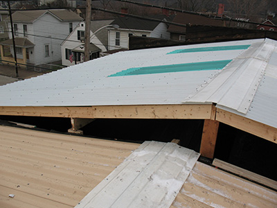 Roof panels with fiberglass ridge cap